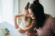 © MeganBetteridge - Mother and Daughter Painting Easter Eggs together