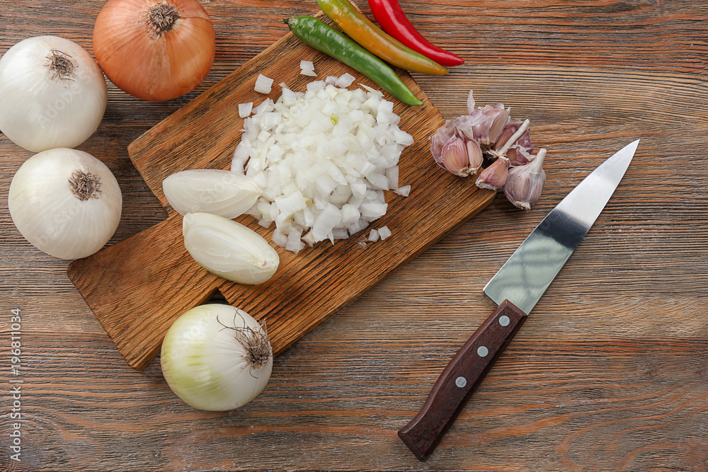 Composition with fresh onions and spices on wooden table
