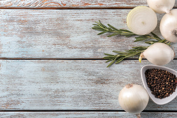 Wall Mural - Raw onion and spices on wooden table
