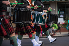 Saint Patrick Day Irish Marching Band Drum Line In Lock Step While Sporting Kilts And Spats.