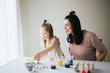 © MeganBetteridge - Mother and Daughter Painting Easter Eggs together