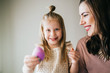 © MeganBetteridge - Mother and Daughter Painting Easter Eggs together