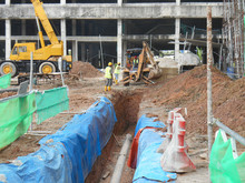 Underground Utility And Services Pipe Lay By Workers At The Construction Site.  