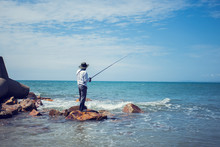 Fisherman Fishing In The Beach Sunny Day