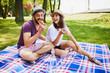 © baranq - Young couple having picnic in park together and eating