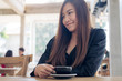 © Farknot Architect - Closeup image of a beautiful asian woman holding and drinking coffee with feeling relaxed in cafe