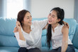 © tuiphotoengineer - two women Competitive friends excited happy cheerful and smiling at home