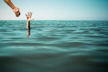 Help Hand For Drowning Man Life Saving In Sea Or Ocean.