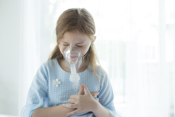 Girl feeling pain in her heart with respiratory mask equipment in hospital. Healthcare and medical concept.