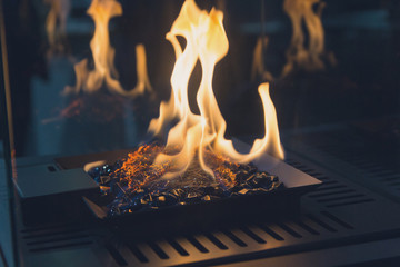 Fire burns in a fireplace with a close up. Interior