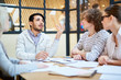 © pressmaster - Young creative manager speculating about his viewpoints or explaining his opinion to colleagues at meeting