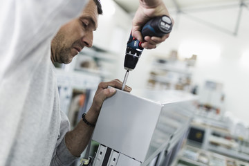 Wall Mural - Manual worker assembling PVC doors and windows. Manufacturing jobs. Selective focus. Factory for aluminum and PVC windows and doors production.