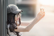 Young beautiful asian woman wearing sunglasses take selfie with smartphone
