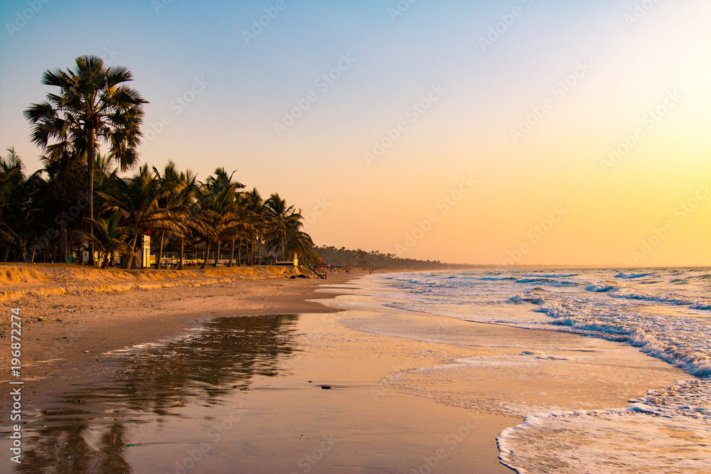 Enjoying the sunset on an idyllic beach in the Gambia, West Africa - obrazy, fototapety, plakaty 