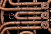 Vintage Bronze Pipes, Valve, Key Mechanical Elements French Horn, Black Background. Good Pattern, Prompt Music Instrument.