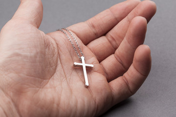 Canvas Print - Silver cross in a hand