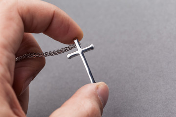 Canvas Print - Silver cross in a hand