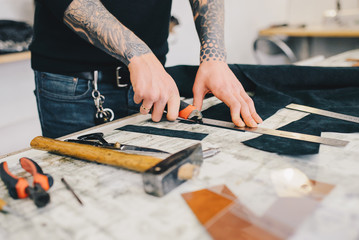 Man working with leather using crafting DIY tools