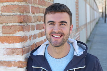 Wall Mural - Gorgeous green eyed smiling man outdoors