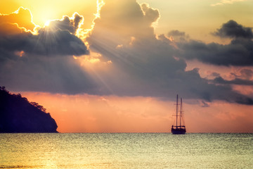 Wall Mural - Beautiful seascape - view of morning sea with a sailboat in the bay of Adrasan, coast of the Mediterranean Sea, Antalya Province, Turkey.