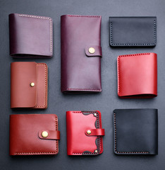 Set of hand made leather man wallet . Multi colored. Leather craft.On dark background.Top view