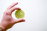Fototapeta Mapy - Hand holding half of green lime