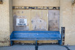 blue painted bench outside old abandoned warehouse in inner city