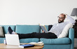 © Rawpixel.com - Bearded man reading on the couch