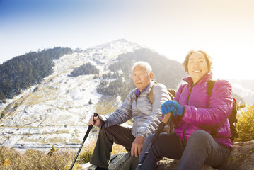 Sticker - happy senior couple hiking on the mountain