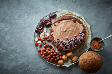 Chocolate vegan cake with different nuts, dates and carob