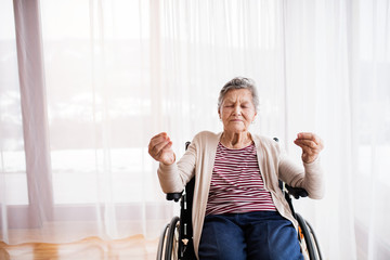 Canvas Print - Senior woman in wheelchair at home.