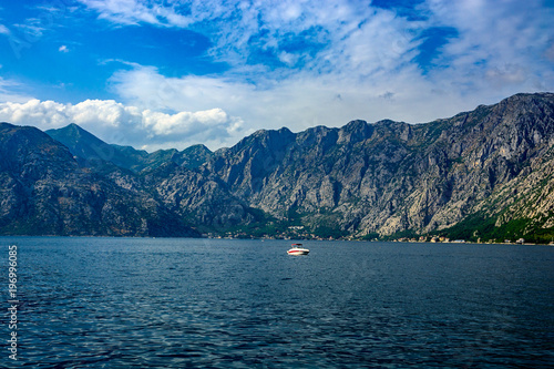 Lonely modern boat in the sea against the background of the mountains Poster