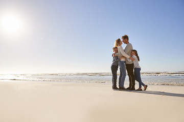 Wall Mural - Loving Family Embracing On Winter Beach