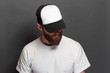 © 4Max - Hipster handsome male model with beard wearing white blank t-shirt and a baseball cap with space for your logo or design in casual urban style
