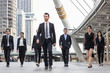 © khwanchai - Teamwork and professional partnership concept, businesspeople team of multi ethnic walking  with confidence in full suit.