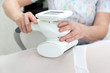 © ALEXEY - Device for removing excess fat. The device for carrying out LPG massage. Application of the device to the client of the beauty salon.