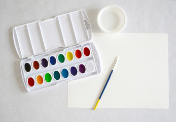 Watercolor Paint Set with paper, brush, and water	