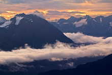 Scenic View Of Snowcapped Mountain Range In Clouds