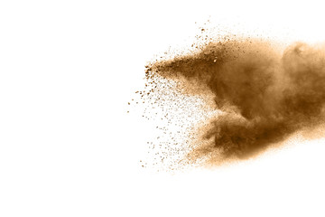 Wall Mural - Freeze motion of brown dust explosion. Stopping the movement of brown powder. Explosive brown powder on white background. Dry soil splater on white background.