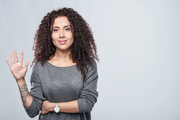 Wall Mural - Hand counting - five fingers. Smiling woman showing five fingers