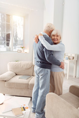 Wall Mural - Hold me close. Happy elderly woman posing for the camera during the dance with her husband while hugging him tightly