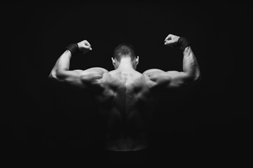 unrecognizable man shows strong back muscles closeup
