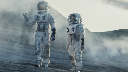 Wall Mural - two astronauts explore rocky alien planet in the day time. near future and technological advance bri