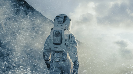 Wall Mural - shot of the astronaut walking through blizzard on alien planet. manned mission to europa, technologi