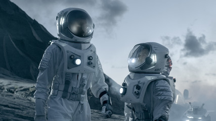 Wall Mural - two astronauts in space suits confidently walking on alien planet, exploration of the the planet's s