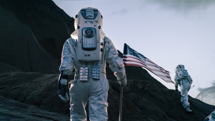 Wall Mural - shot of the two astronauts exploring mars/ red planet. one cosmonaut carries american flag. technolo