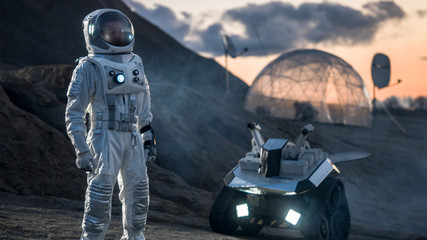 Wall Mural - astronaut in space suit confidently standing on alien planet, exploration of the the planet's surfac