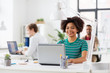 © Syda Productions - happy african woman with laptop computer at office