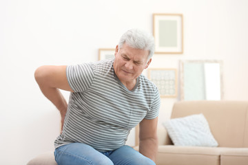 Poster - Mature man suffering from back pain at home