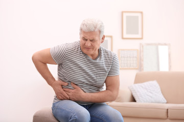 Poster - Mature man suffering from pain in his side at home